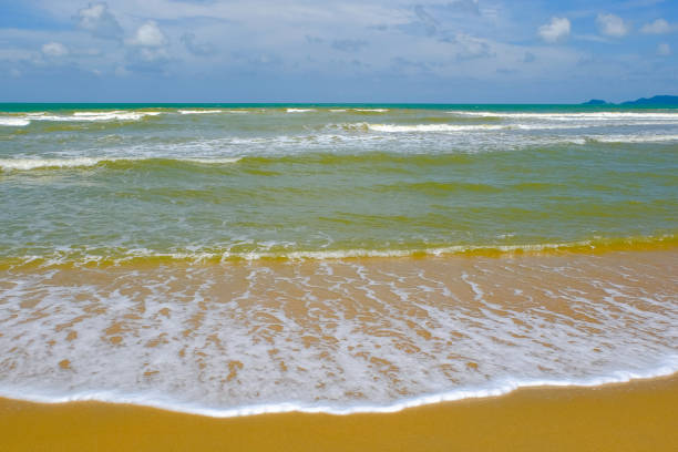 Beautiful blue ocean waves in Terengganu, Malaysia with cloudy sky background at sunny day