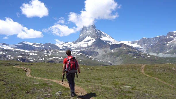 istock Young Caucasian Man With Backpack Hiking in Mountains 1029614030