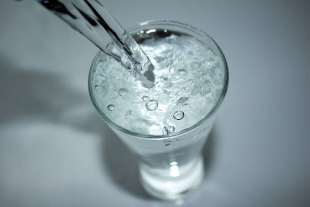 istock water splashing from glass on white background 1029622400