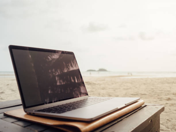 istock Laptop computer on the table in the beach. 1029627892