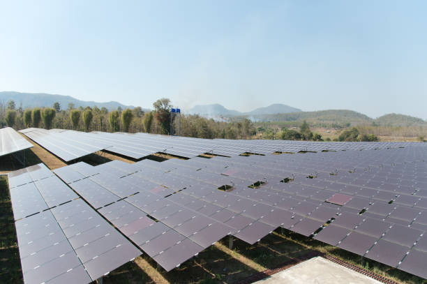 istock View of solar farm in sunlight with blue sky, dirty solar cell  array, green energy concept. 1029635322