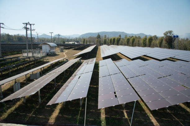 View of solar farm in sunlight with blue sky, dirty solar cell  array, green energy concept.