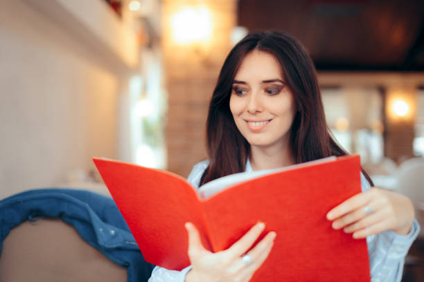 istock Woman Reading Menu in a Restaurant Deciding to Order 1029635480