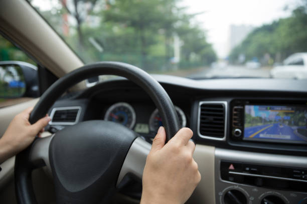 istock Hands holding steering wheel driving car on road 1029637850