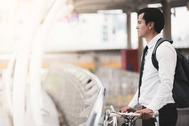 istock Business man worker riding bicycles in city 1029656472
