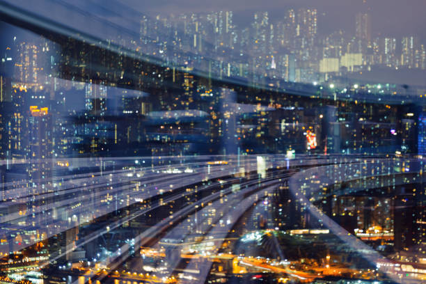 istock Train track curved over residence downtown night blur light 1029657070