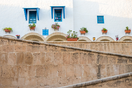 Beautiful ornamental blue windows on a white wall, Yasmine Hammamet, Tunisia