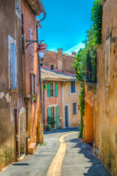 una strada stretta nel villaggio di roussillon in francia - cave church foto e immagini stock