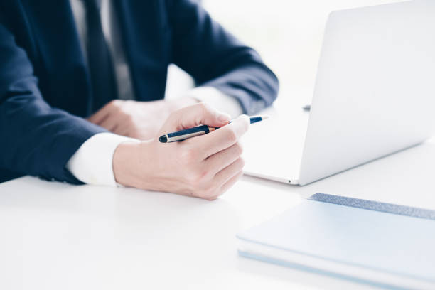 istock Businessman working, Hand holding pen and using laptop computer in modern office, Business and Office concept. 1029674946