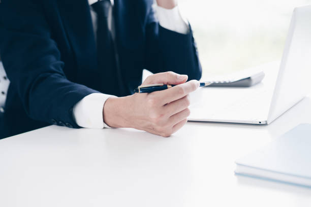 istock Businessman working, Hand holding pen and using laptop computer in modern office, Business and Office concept. 1029674974