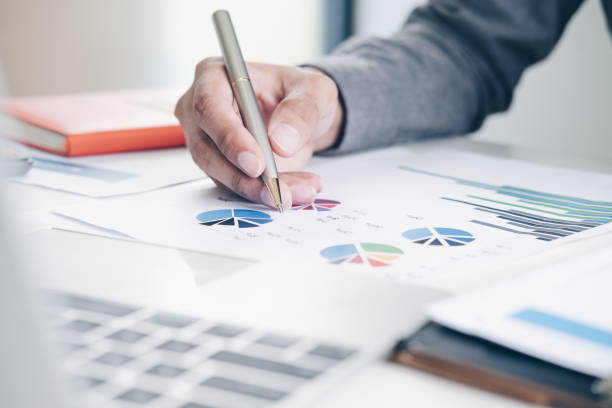 istock Businessman analyzing investment data charts by using his laptop and calculator in modern office, Business and Office concept. 1029678138