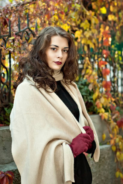 istock woman in a  coat walks in autumn park 1029678406