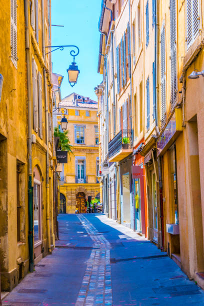 a narrow street in the center of Aix-en-Provence, France a narrow street in the center of Aix-en-Provence, France bouches du rhone photos stock pictures, royalty-free photos & images