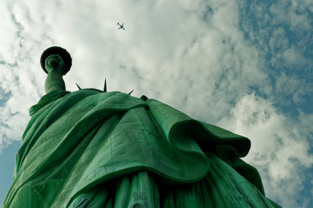 istock Statue of Liberty and a plane 1029692544