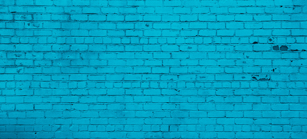Panoramic Brick wall Background Texture. Restored Old brick wall painted in turquoise color. Wide Angle Horizontal Wallpaper or Web banner With Copy Space for Design, Close up