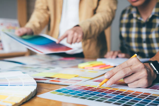 istock Young creative team having a meeting in creative office, Architectural drawing with work tools and accessories, Color swatch samples chart for selection coloring 1029711568