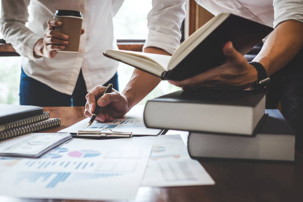 istock Business team are meeting and discussing marketing plan and pointing graph report analyzing financial figures denoting the progress in the work 1029711576
