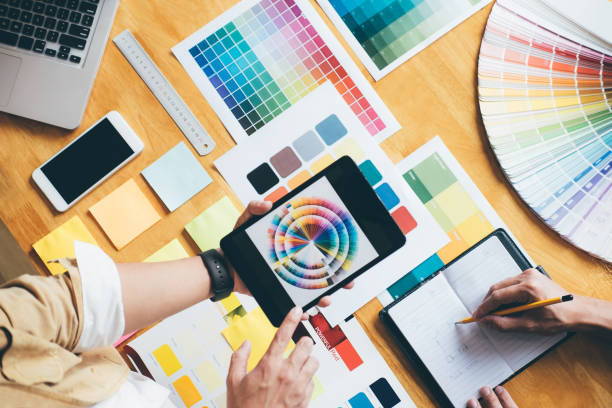 istock Young creative team having a meeting in creative office, Architectural drawing with work tools and accessories, Color swatch samples chart for selection coloring 1029713952