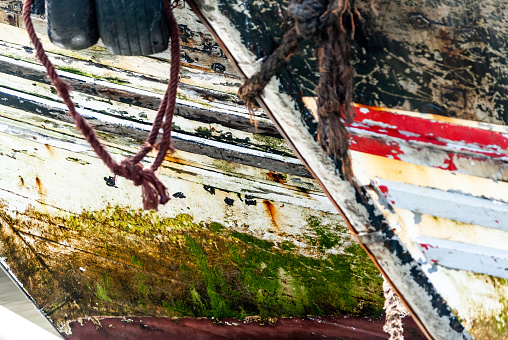 Close up on the hulls of fishing boats anchored in the port of Essaouira in Morocco