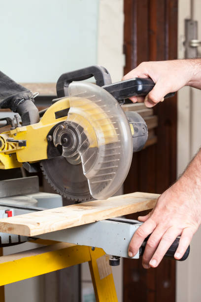istock carpenter cutting with electric sawdust 1029716966