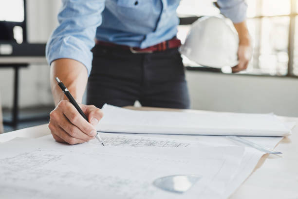 istock Construction concept, Hands of architect or engineer working for new project plan on blueprint, model building and engineering tools in working site 1029717250