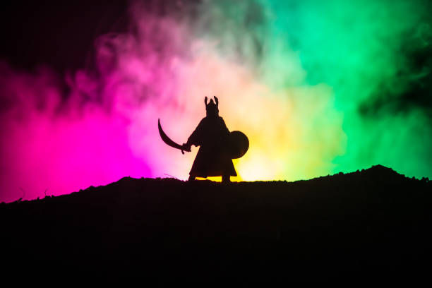 istock Fighter with a sword silhouette a sky. Medieval knight with sword. Selective focus 1029717396