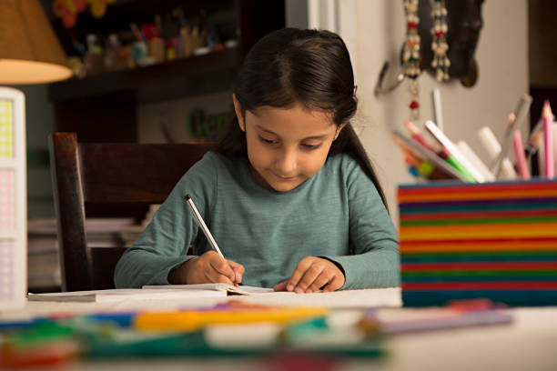 girl doing homework at home - stock image - homework pencil people indoors imagens e fotografias de stock