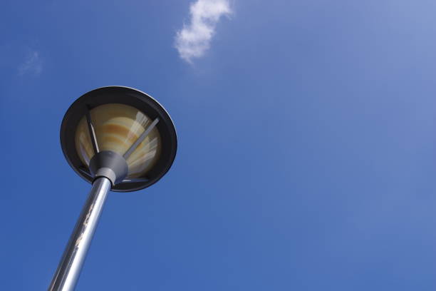 a lamppost and blue sky for background