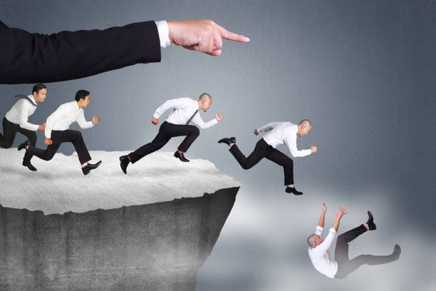 Bad Leader Give Wrong Direction Bad direction in business concept. Big leader hand giving wrong direction causine his workers falling down at the edge of a cliff evil stock pictures, royalty-free photos & images