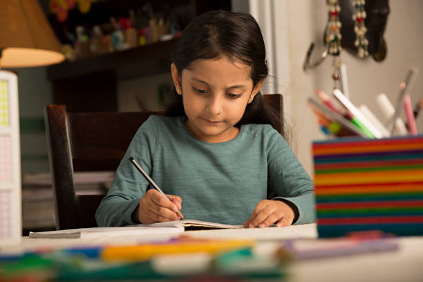 istock Girl doing homework at home - Stock image 1029723416