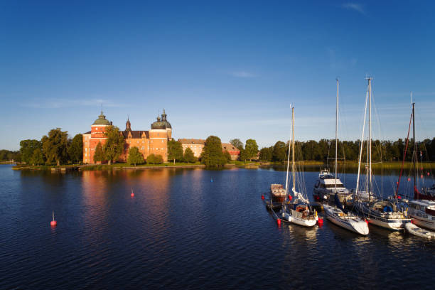 Gripsholm castle Mariefred, Sweden - August 18, 2018: Morning light at the 16th century Gripsholm castle and part of the marina with pleasure boats visable. mariefred stock pictures, royalty-free photos & images