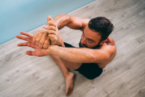 istock Young man doing yoga exercise isolated on a white background 1029727960
