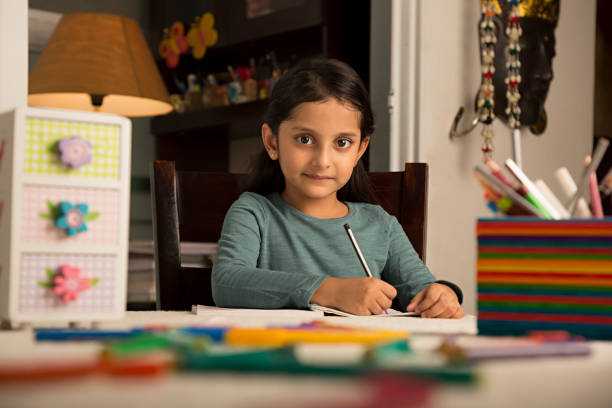 istock Girl doing homework at home - Stock image 1029730700