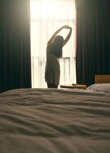 istock Stretching in front of bedroom window 1029730880