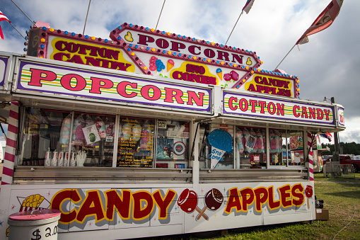 Cheboygan, Michigan, USA - August 9, 2018: Carnival food booth concessionaire at the Cheboygan County Fair in Michigan.