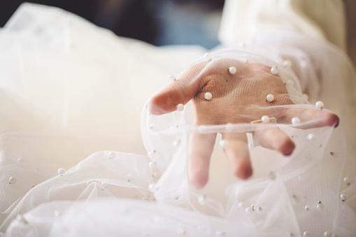 Fashion designer is working with veil