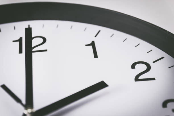 istock Close up of black and white analog clock with selective focus at 2 Oclock 1029750376