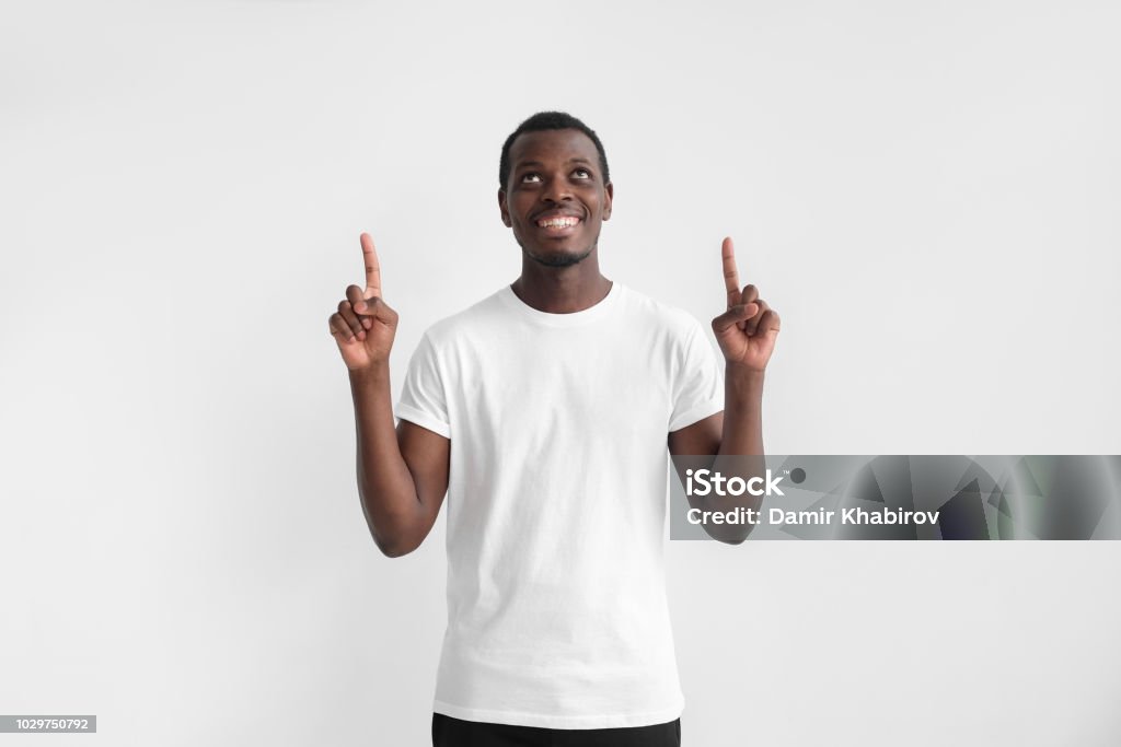 Handsome African Amreican Man In White Tshirt Pointing Up With Two ...