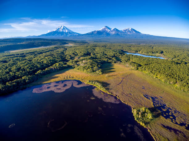 Aerial shot of lake and volcanoes at golden hour stock photo