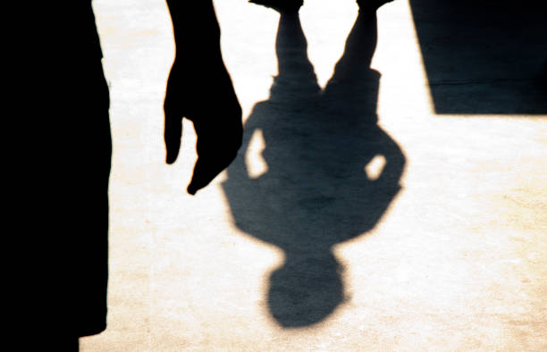 Blurry shadow silhouette of two boys confronting each other stock photo