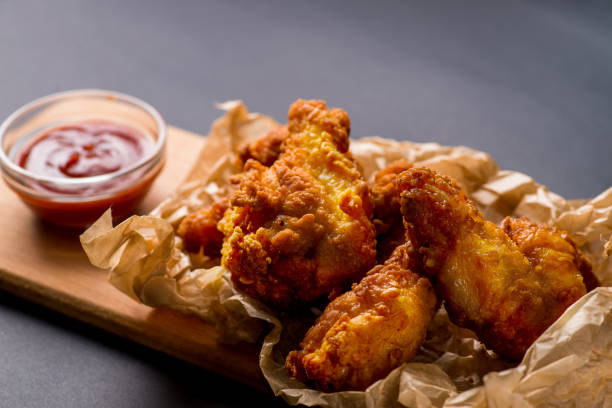istock fried  chicken wings nuggets with ketchup 1029771496