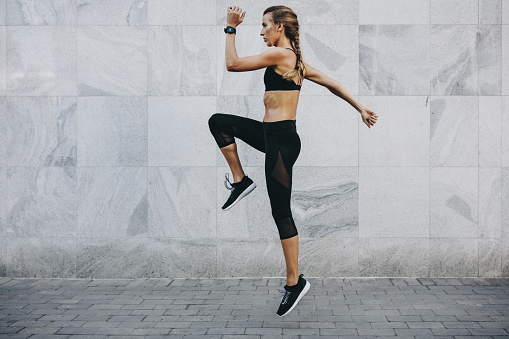 Women in fitness wear exercising outdoors. Fitness women doing workout in the morning.