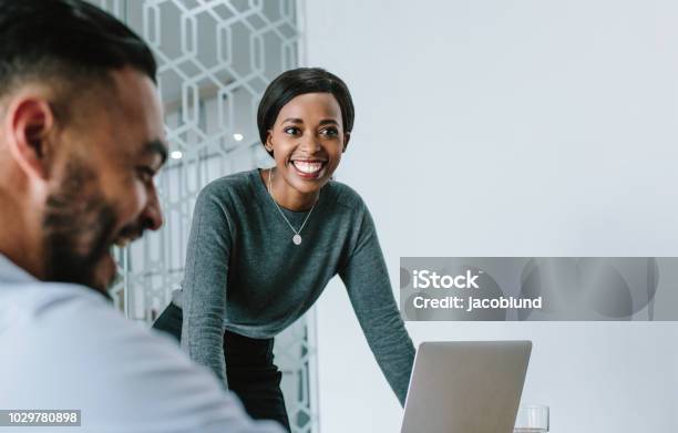 Businesswoman Smiling During Presentation Stock Photo - Download Image Now - Business, Business Meeting, African Ethnicity