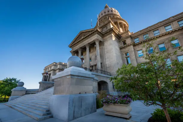 View looking up at the entrance of the Idaho State Capitol Building in Boise, ID on a clear morning.