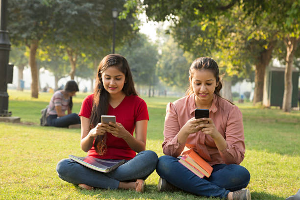 istock friends watching videos on a smartphone - Stock image 1029792156