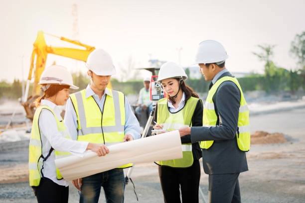 engineer surveyor working with theodolite at construction site