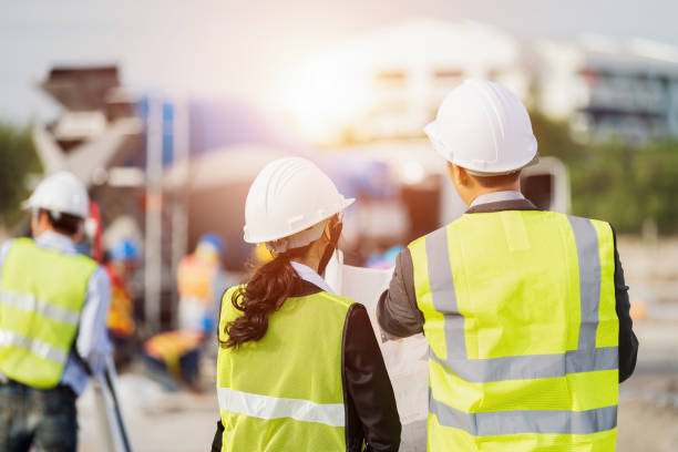 homme d’affaires et femme d’affaires à l’aide voir plan étude sur chantier - building contractor manual worker construction worker repairman photos et images de collection