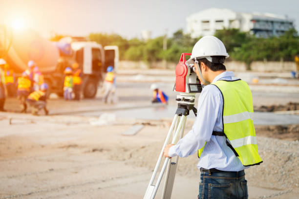 Engineer surveyor working with theodolite at construction site Engineer surveyor working with theodolite at construction site af_istocker stock pictures, royalty-free photos & images