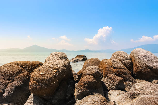 istock Beach Vacation Smooth Rocky Shore Blue Water Ocean Travel 1029798042