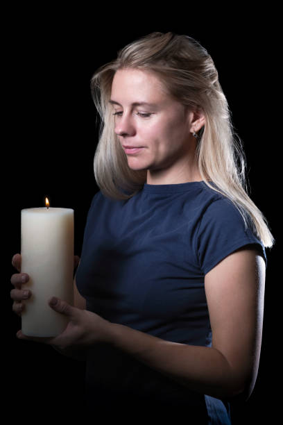 istock Woman with a candle in the dark 1029804390
